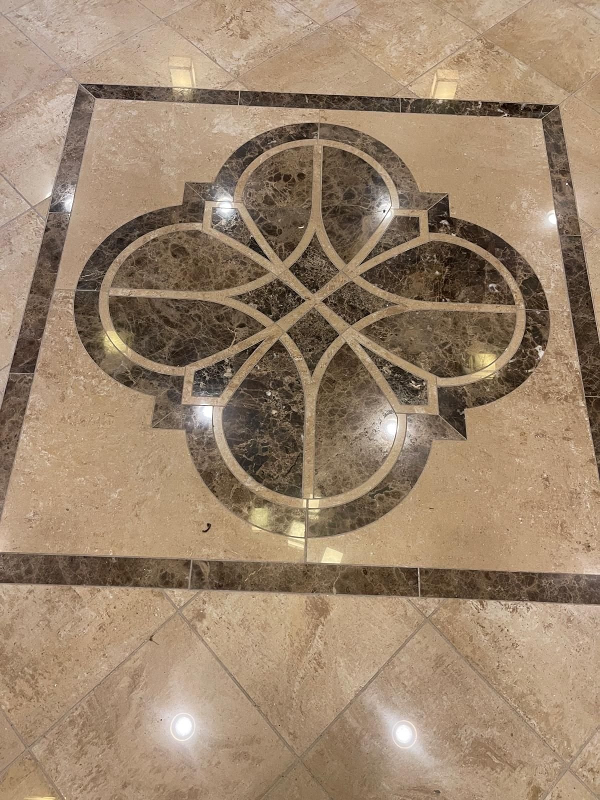 Quatrefoil mosaic medallion framed by a running border — emperador and crema marble, custom commission