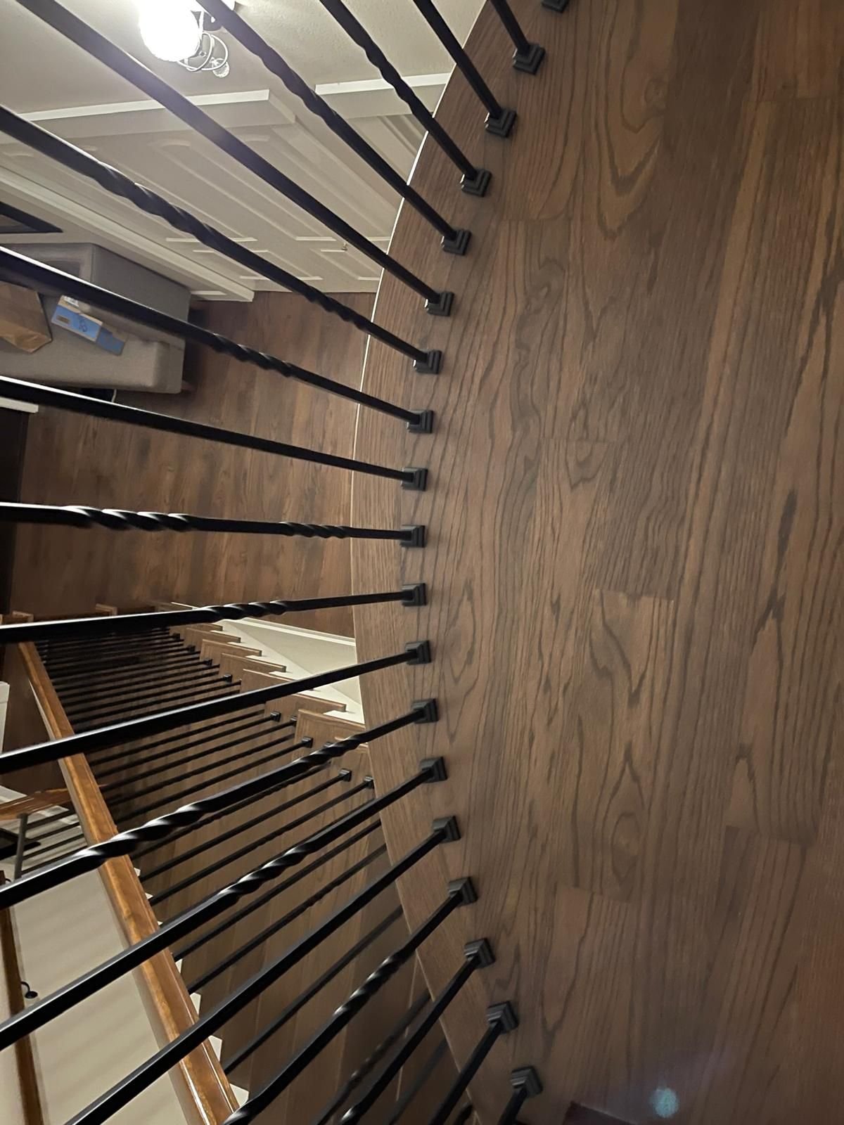 Staircase with forged iron balusters and a continuous handrail — white oak, custom commission