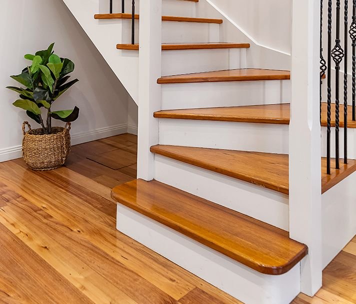 Painted staircase with light oak treads meeting a matching floor — oak, custom commission