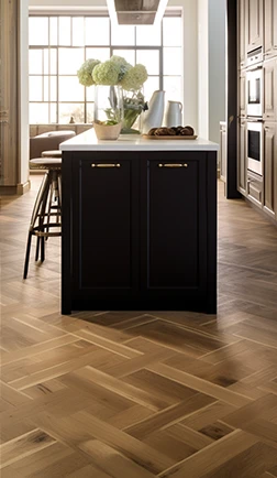 Patterned parquet floor in a modern kitchen with a dark island