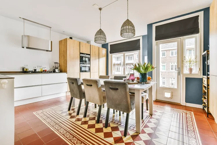 Dining area of a modern apartment with patterned wood flooring