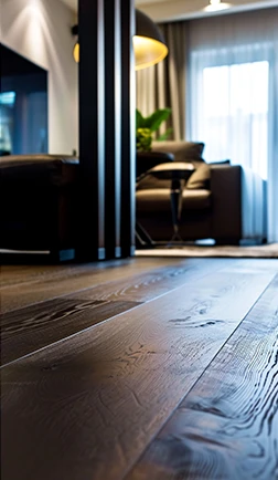 Dark plank flooring running into an open living space
