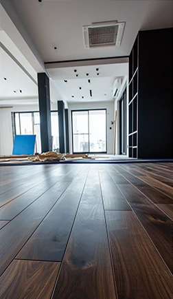 Smoothly finished hardwood floor in a modern room with large windows