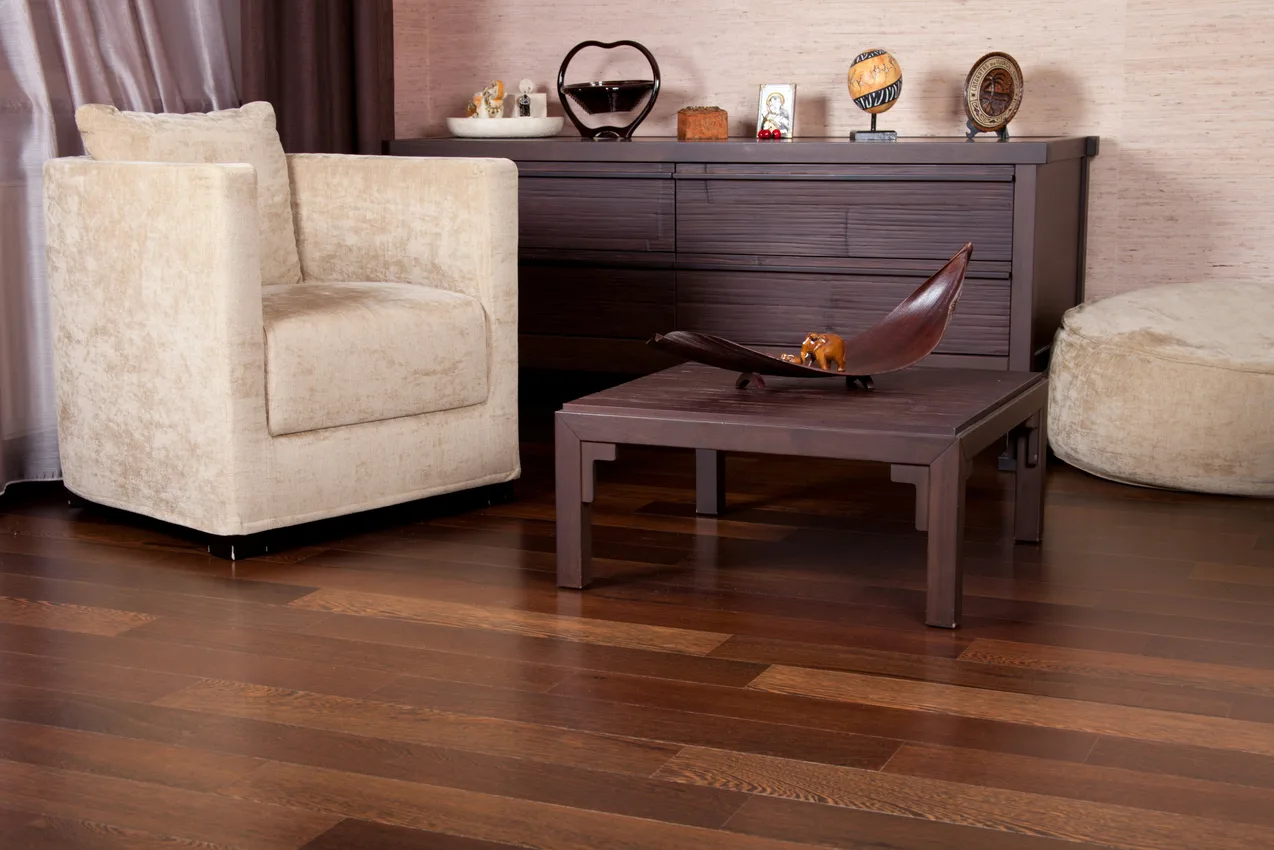 Cozy living room with a sofa over warm wood-look plank flooring