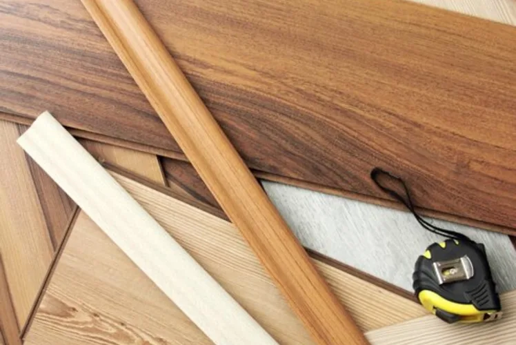 Laminate planks and tools laid out mid-installation