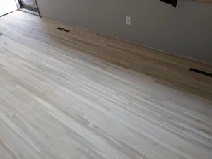 The same floor sanded and refinished to a clean, light finish by AG Floor Covering