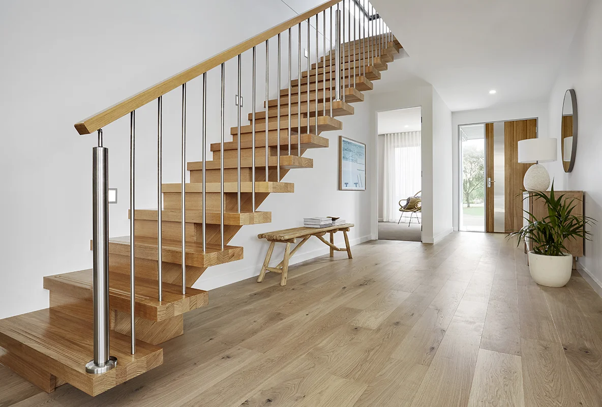Modern hardwood staircase with clean lines in a bright interior