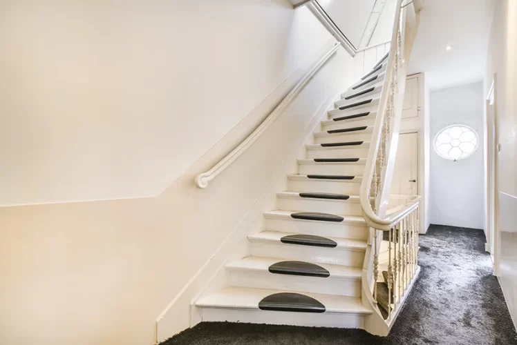Wooden staircase in the spacious hall of an apartment